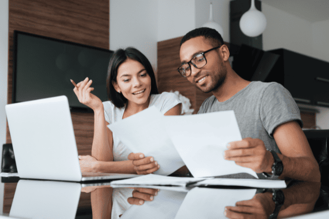 Couple reviewing costs of SMSF loans versus traditional property loans in Australia Couple reviewing costs of SMSF loans versus traditional property loans in Australia
