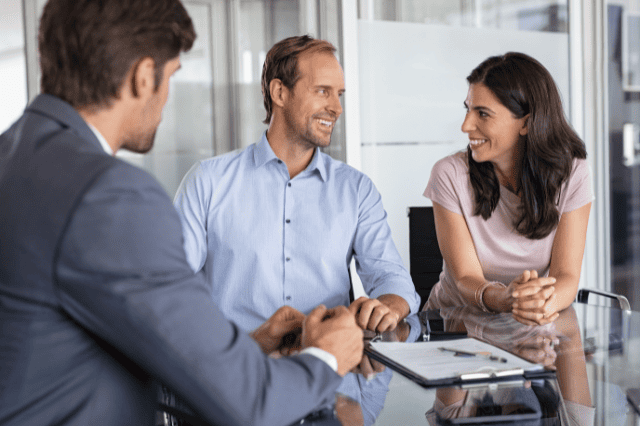 Engineer couple meeting with mortgage broker to explore home loan benefits and options Engineer couple meeting with mortgage broker to explore home loan benefits and options