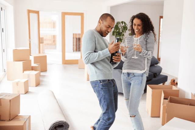 Happy new homeowners enjoying smart mortgage management benefits Happy new homeowners enjoying smart mortgage management benefits