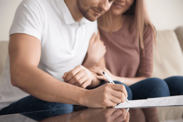 Queensland teacher couple reviewing mortgage paperwork Queensland teacher couple reviewing mortgage paperwork