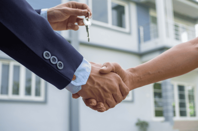 Handshake after property deal with mortgage broker for investment lending support Handshake after property deal with mortgage broker for investment lending support